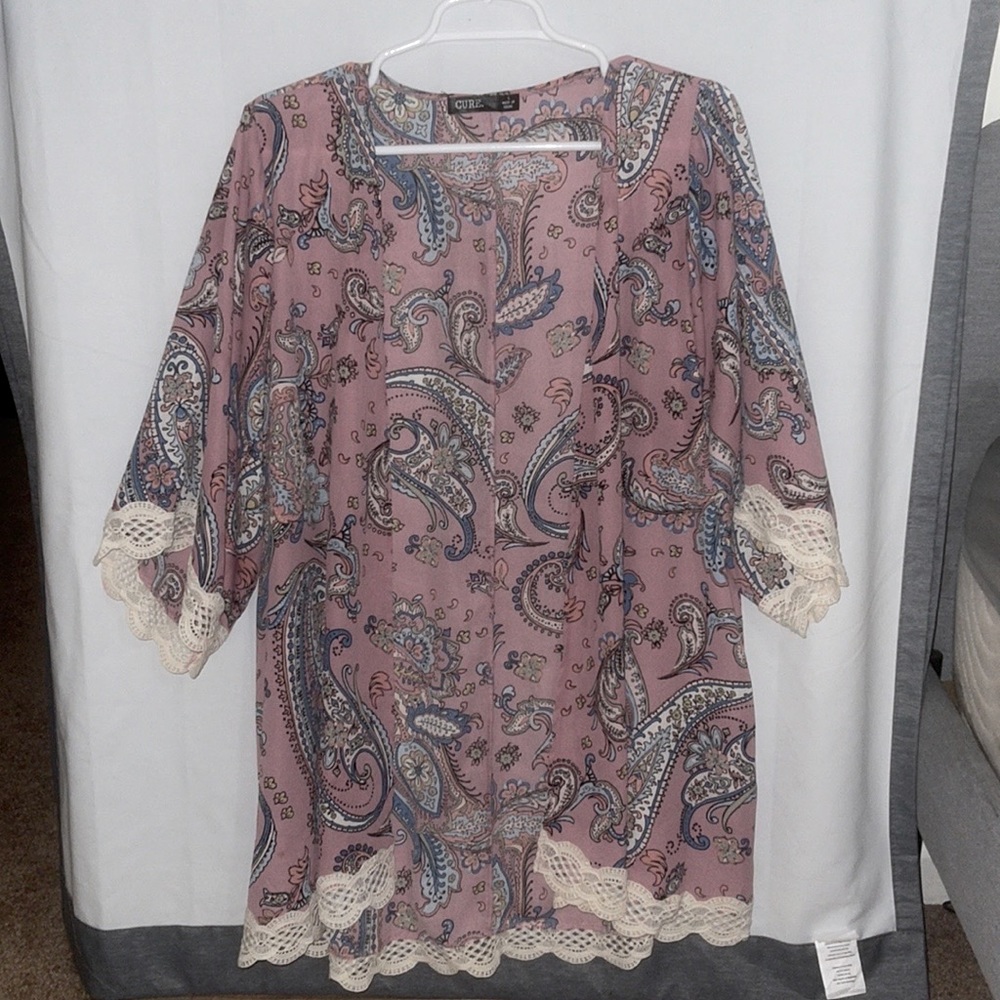 Woman’s large light pink cardigan